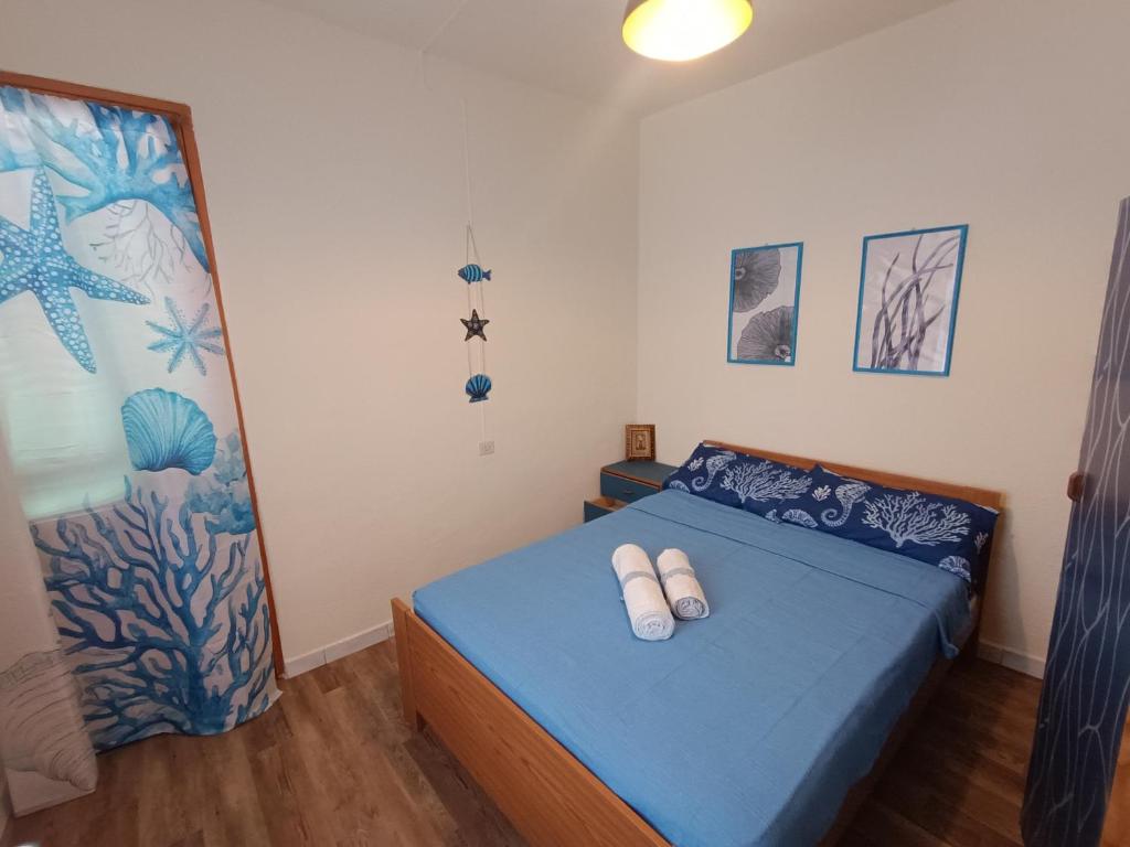 a bedroom with a bed with two white pillows on it at Casa Alby in Nulvi