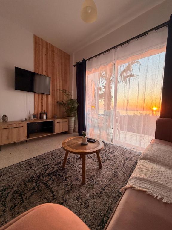 a living room with a couch and a table at Two Bedroom Sea View Townhouse-Villa Libellula in Khlorakas