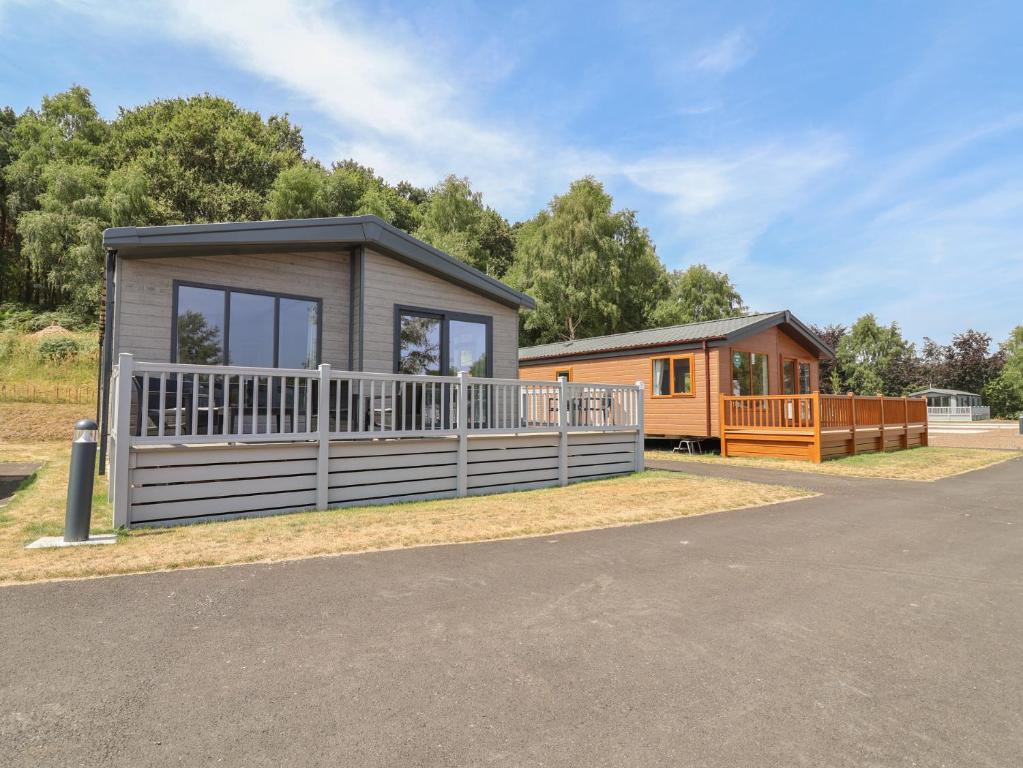 a couple of modular homes in a park at Cedar Lodge 2 Bedrooms with hot tub in Northwich