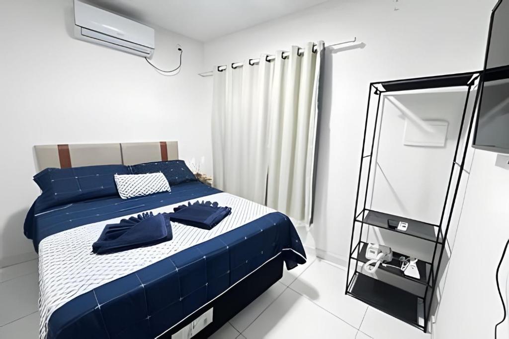 a bedroom with a blue bed and a mirror at Abaíra Serra Azul Loft 6 - Orla - Centro in Petrolina