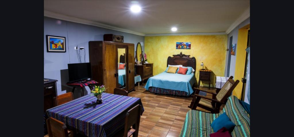 a bedroom with a bed and a table in a room at Xelanos in Quetzaltenango