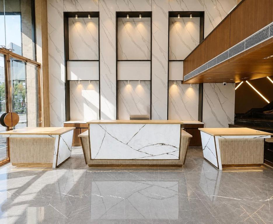 a lobby with benches and tables in a building at The Prime Delhi in New Delhi