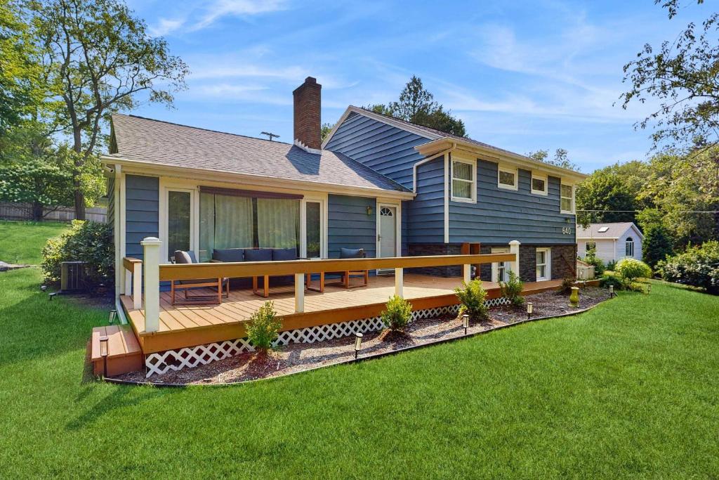a house with a large wooden deck in the yard at Gathering Place in Frankfort