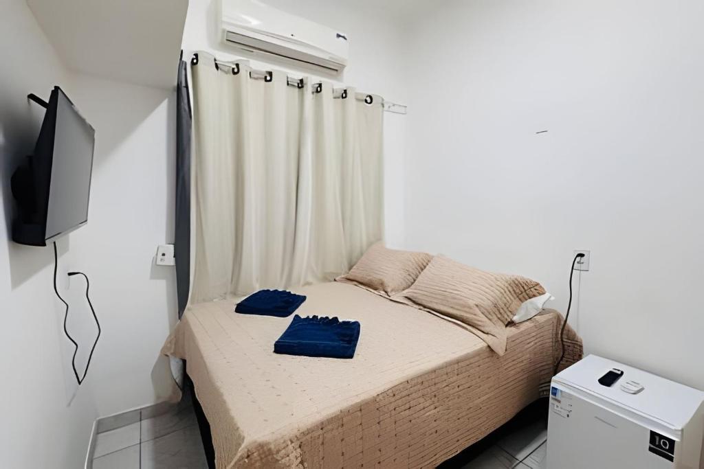 a small bedroom with a bed and a window at Abaíra Serra Azul Suítes 01 - Centro in Petrolina