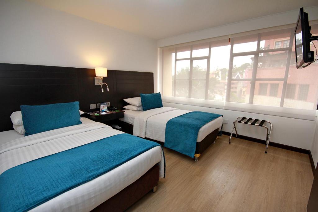 Postel nebo postele na pokoji v ubytování Hotel Dann Cali