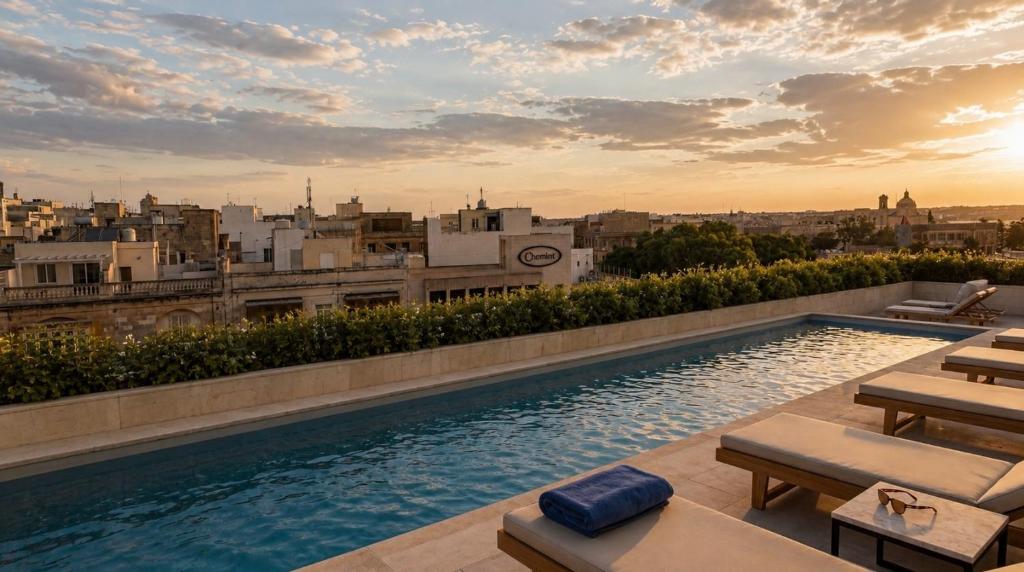 a pool on the roof of a building with a view at St Anne Palace by Tritoni Prestige in Il-Furjana