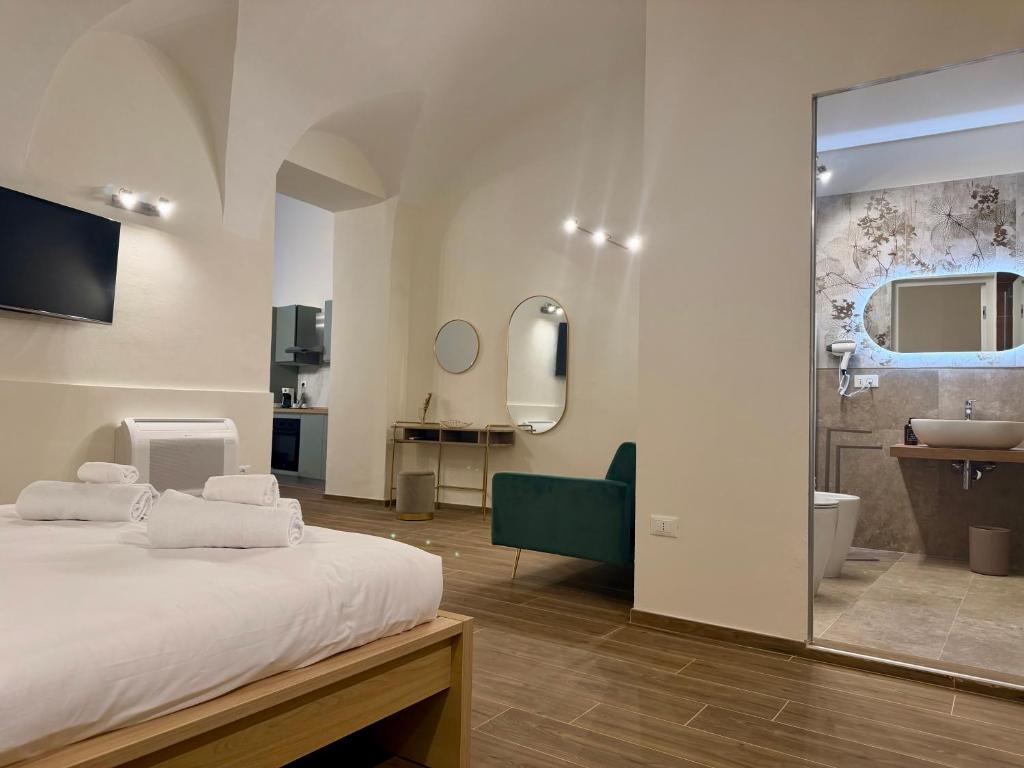 a bedroom with a bed and a bathroom with a sink at Majella vista Mare in Guardiagrele