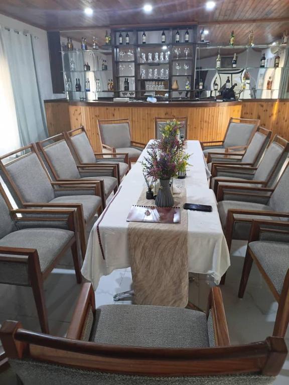 a row of tables and chairs in a restaurant at Ursa lodge in Lubumbashi