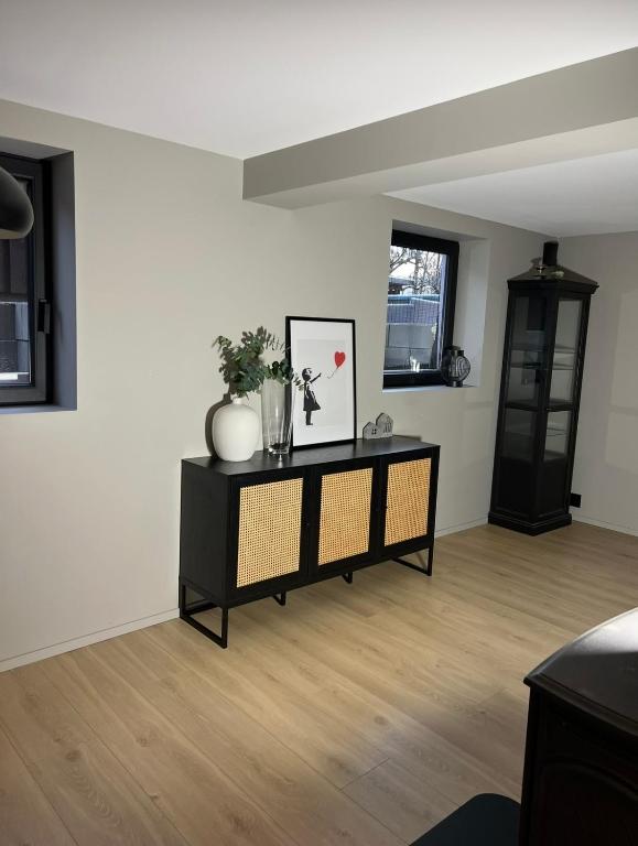 a living room with a table with a picture on it at The Eikorn House in Skien