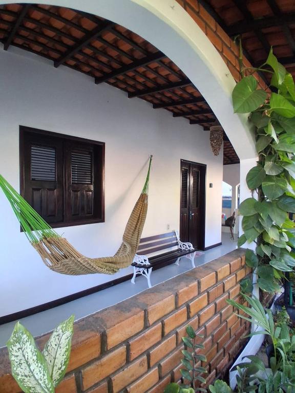 a patio with two hammocks on a house at Garden House - Atins in Atins