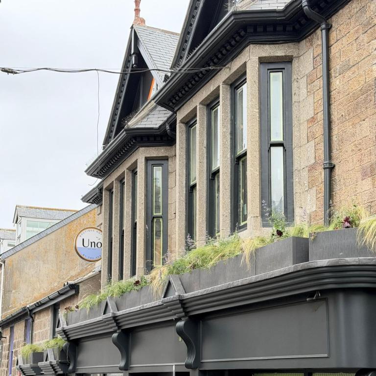 a building with windows and plants on it at Uno By The Sea - Boutique Hotel in St Ives