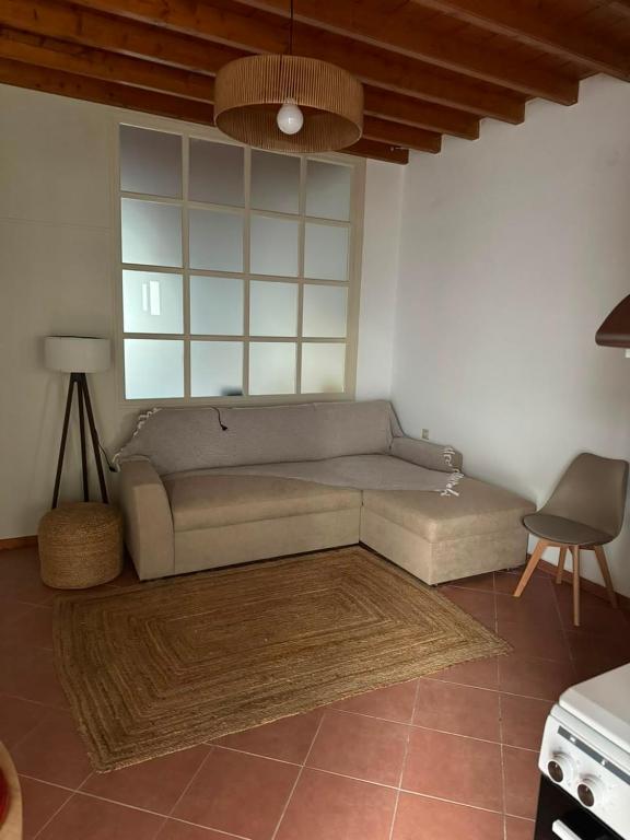 a living room with a couch and a table at Marea Patmos in Skala