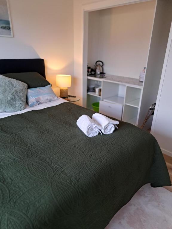 a bedroom with a bed with two towels on it at Kupe Retreat free wifi free parking two rooms ensuite bathroom for both in Whitianga