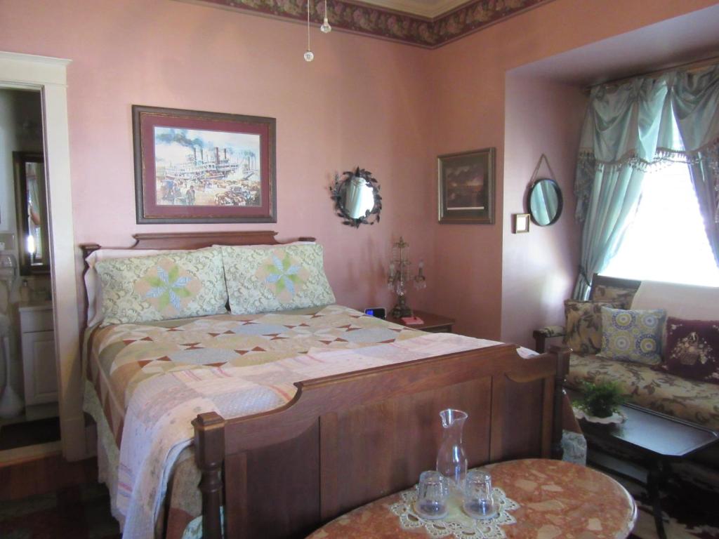 a bedroom with a bed and a table and a chair at The Carriage House in Jefferson