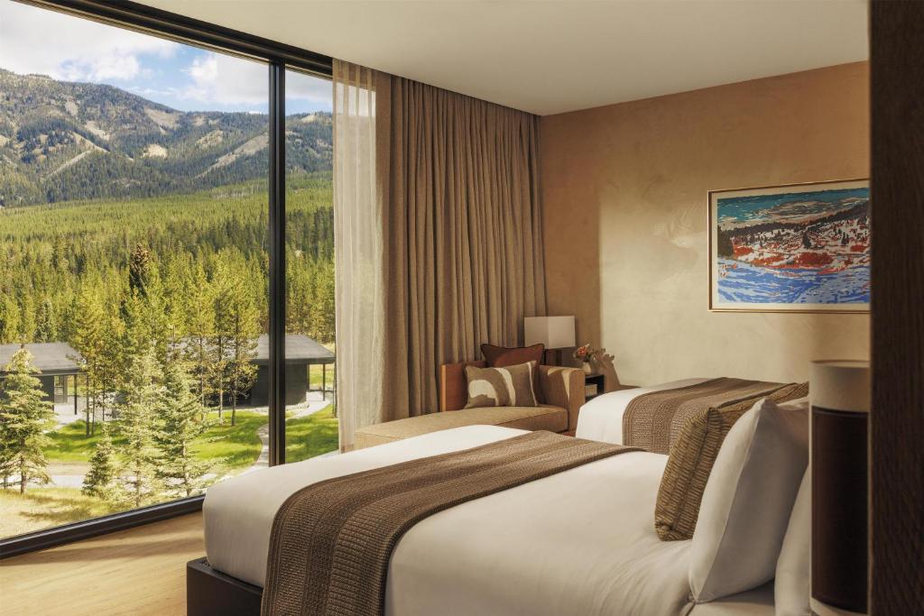 a hotel room with two beds and a large window at One&Only Moonlight Basin in Big Sky
