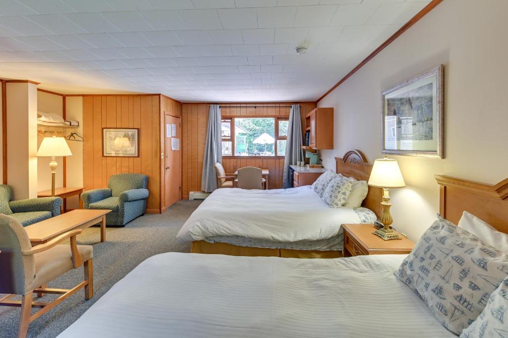 a hotel room with two beds and two chairs at Lake Champlain Studio: Fish, Play & Relax in Willsboro