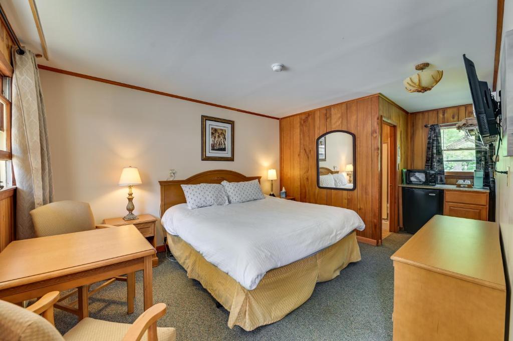 a hotel room with a bed and a desk at Lakeside Fun! Willsboro Studio w/ Dock + Fire Pit in Willsboro