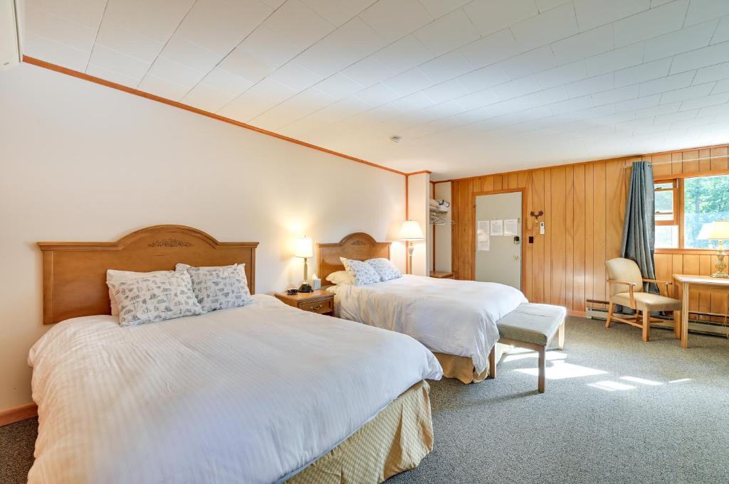 a bedroom with two beds and a table and chairs at Lake Champlain On-Site! Waterfront Studio w/ Dock in Willsboro