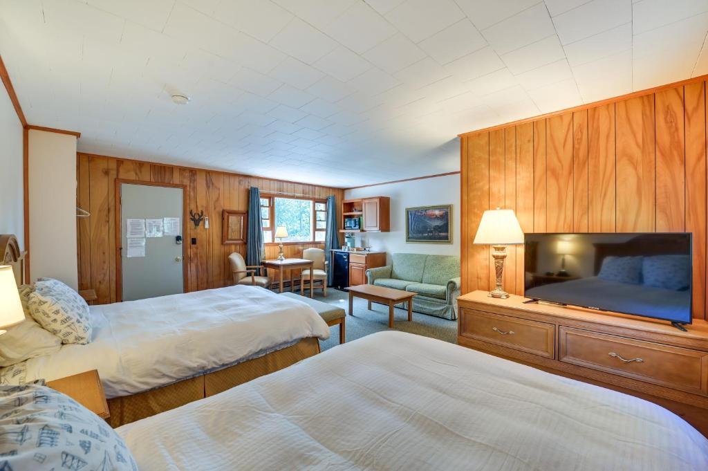 a hotel room with two beds and a television at Lake Champlain Retreat w/ Dock, Games & More in Willsboro