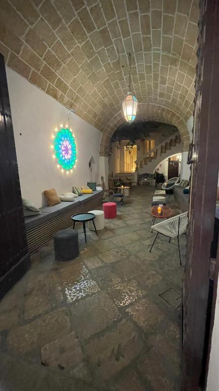 a living room with a couch and tables and a ceiling at Chicca's Apartments Gallipoli in Gallipoli