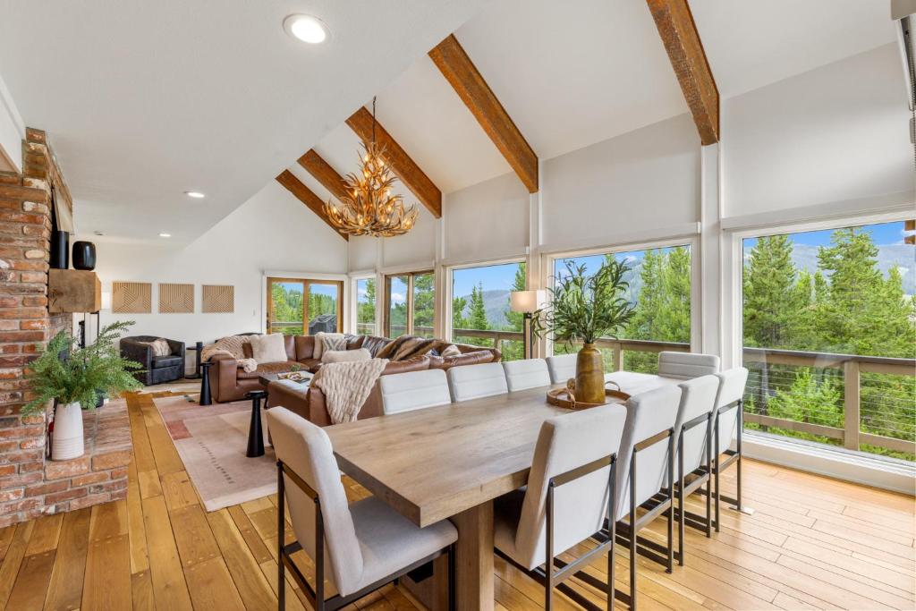 a dining room and living room with a table and chairs at Lone Mountain Lookout in Big Sky
