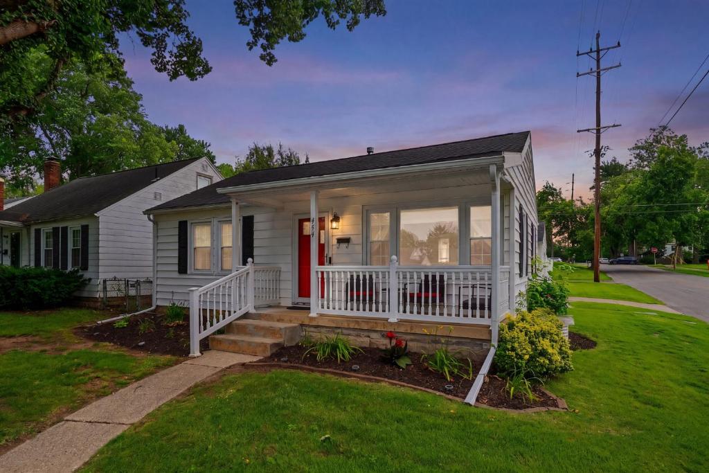 a small white house with a red door at Cozy Corner in Terre Haute