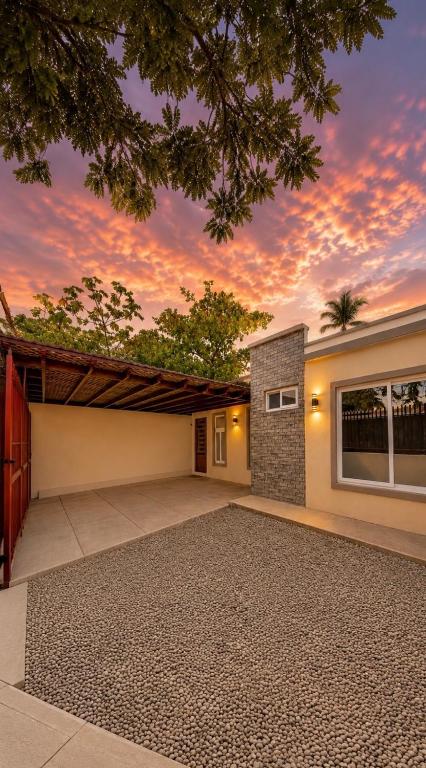 a house with a garage with a sunset at Nandos Places in Puerto Barrios