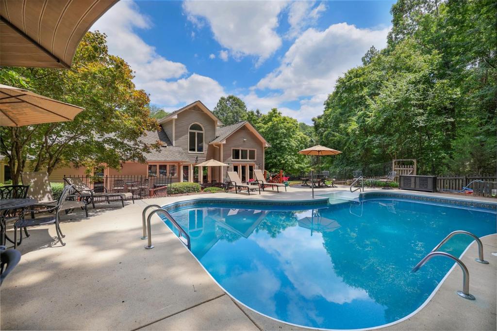 a swimming pool in front of a house at Lg Pool House w Hot Tub Central to RTPPool OPEN in Durham