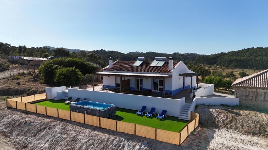 an aerial view of a house with a swimming pool at Monte da Caniveta - Casa dos Compadres in São Luis