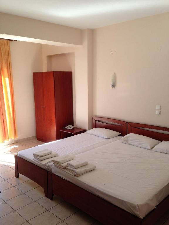 Postel nebo postele na pokoji v ubytování Hotel Akrogiali