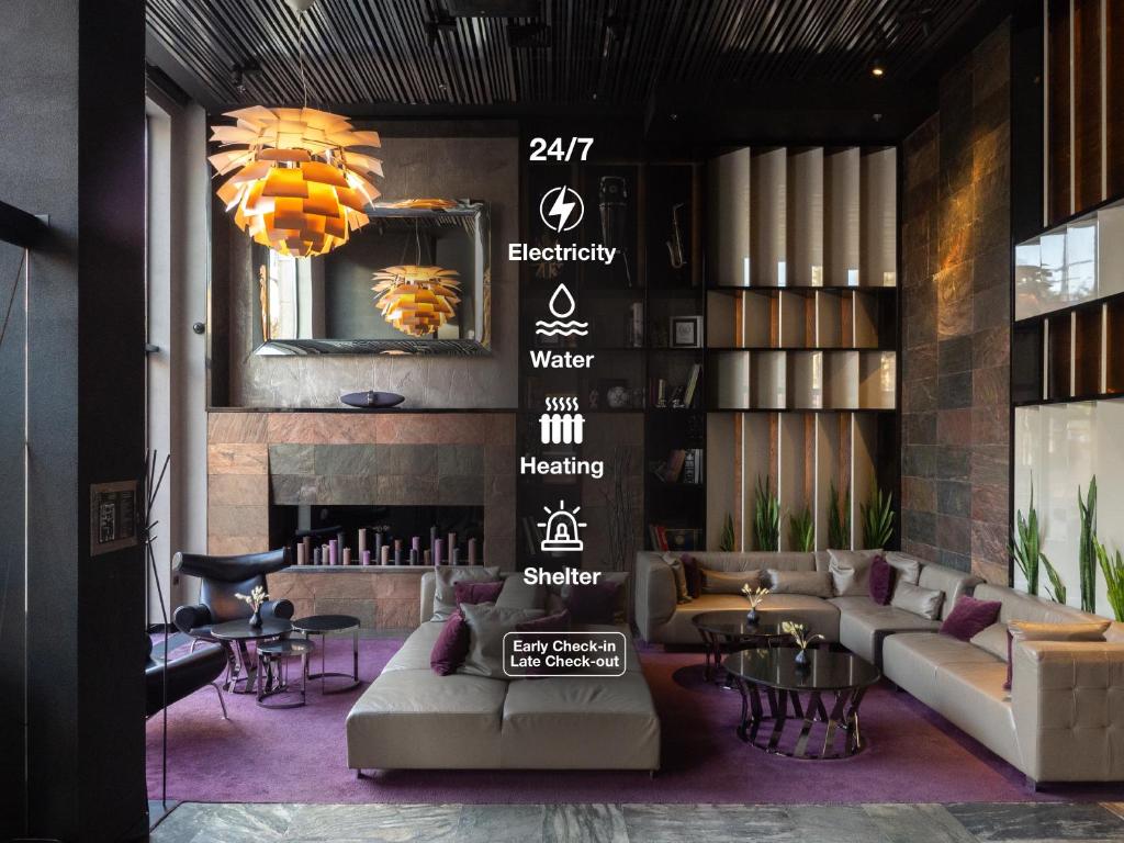 a lobby with couches and tables and a fireplace at 11 Mirrors Design Hotel in Kyiv