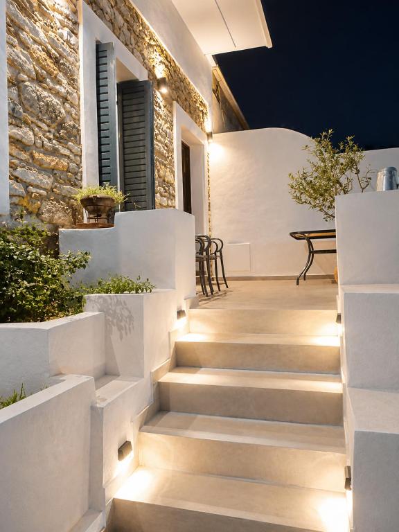 a staircase in a house with lights on the stairs at Angelouda's House - Traditional Stone 2 BR Home in Karystos Center in Karistos