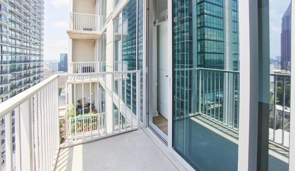 a balcony in a building with views of the city at SE Furnished Apartment in Atlanta