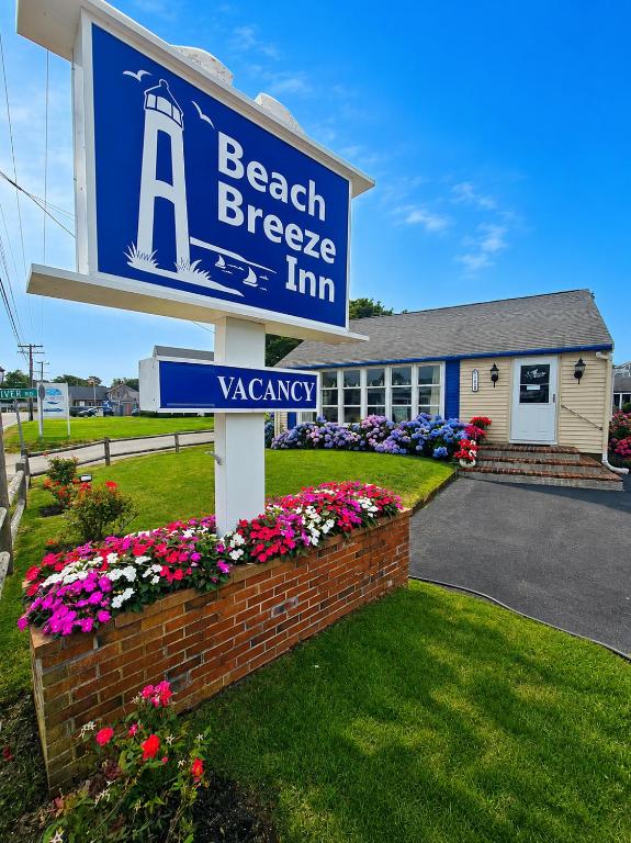 a sign for a beach breeze inn in front of a building at A Beach Breeze Inn in West Harwich