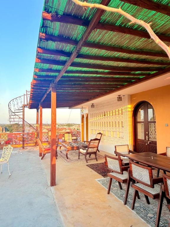 a patio with wooden tables and chairs on a building at Bakarani in Mombasa