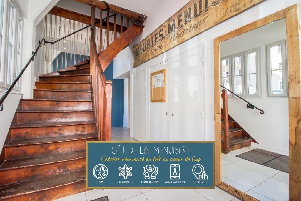 a staircase in a building with a sign in front of it at Gîte de La Menuiserie in Gap