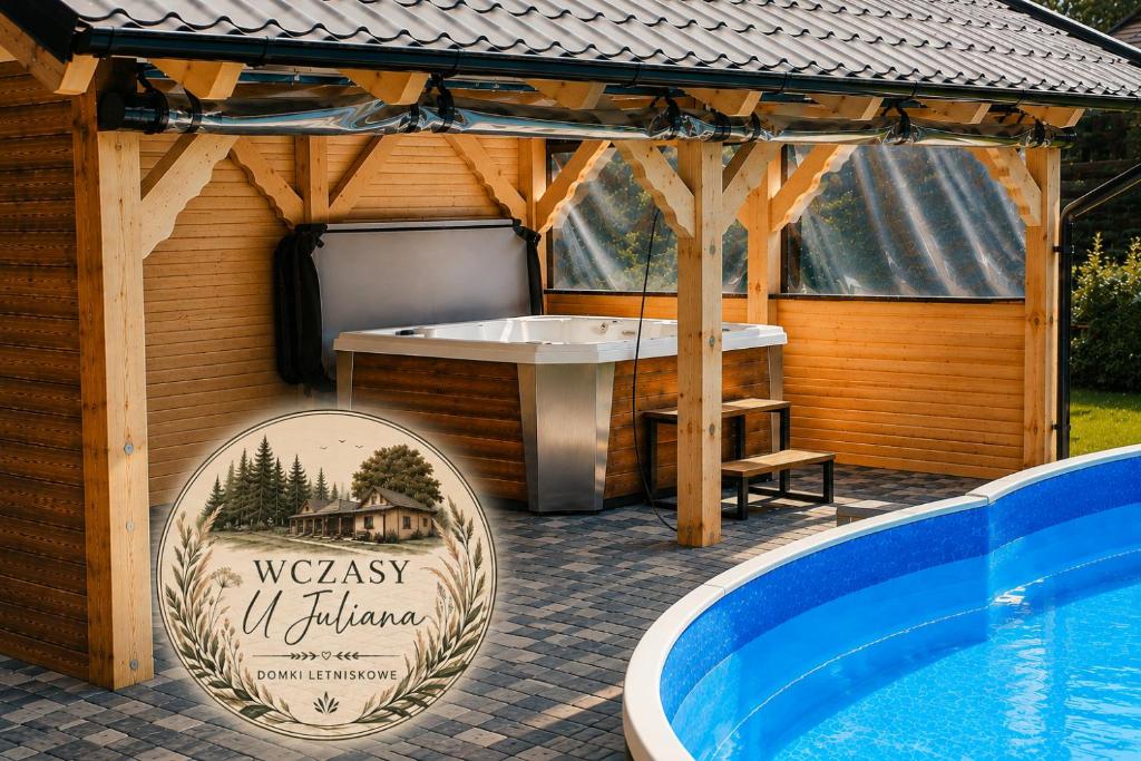 a wellness center sign next to a swimming pool at Wczasy u Juliana in Drewnica