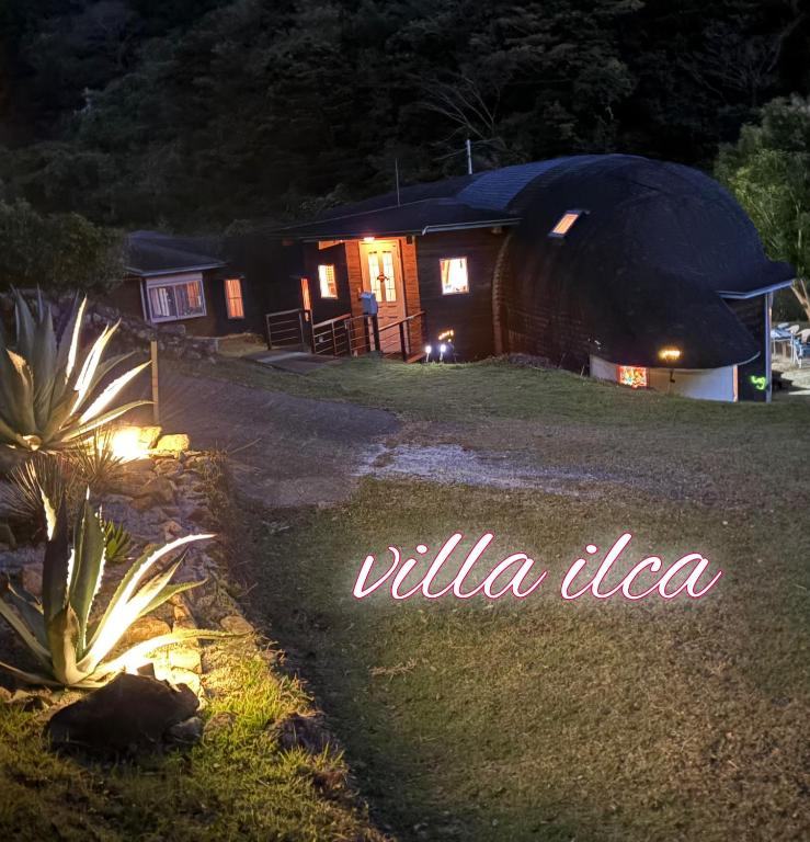 a night view of a yurt with the words willa idea at ilca イルカの家 -Kumano Kodo Nagaizaka- in Susami