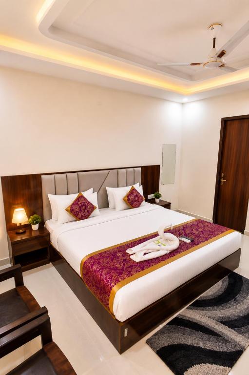 a bedroom with a large bed in a room at hotel urban ade in Tājganj