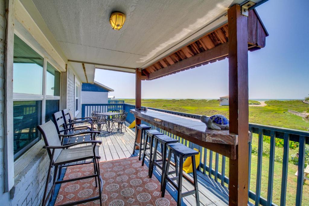 a balcony with chairs and a bar with a view of the ocean at 'Sea-King Sol' Ocean-View Condo in Port Aransas! in Port Aransas