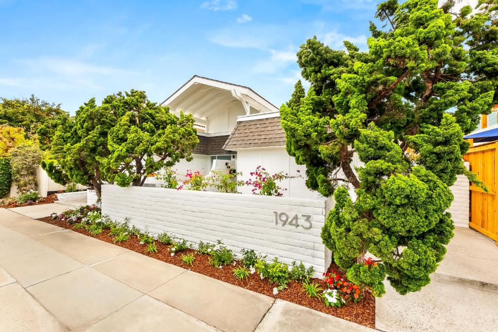a white fence in front of a house at Designer Del Mar Escape Beach Dining & Shops in San Diego