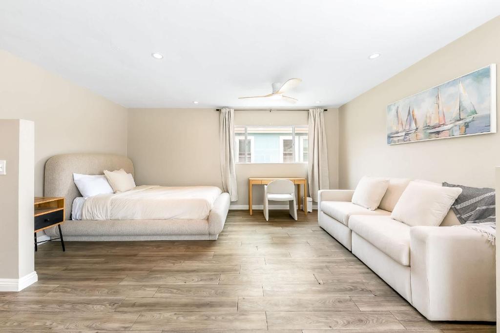 a living room with a bed and a couch at Del Mar Studio - Walk to Beach in San Diego