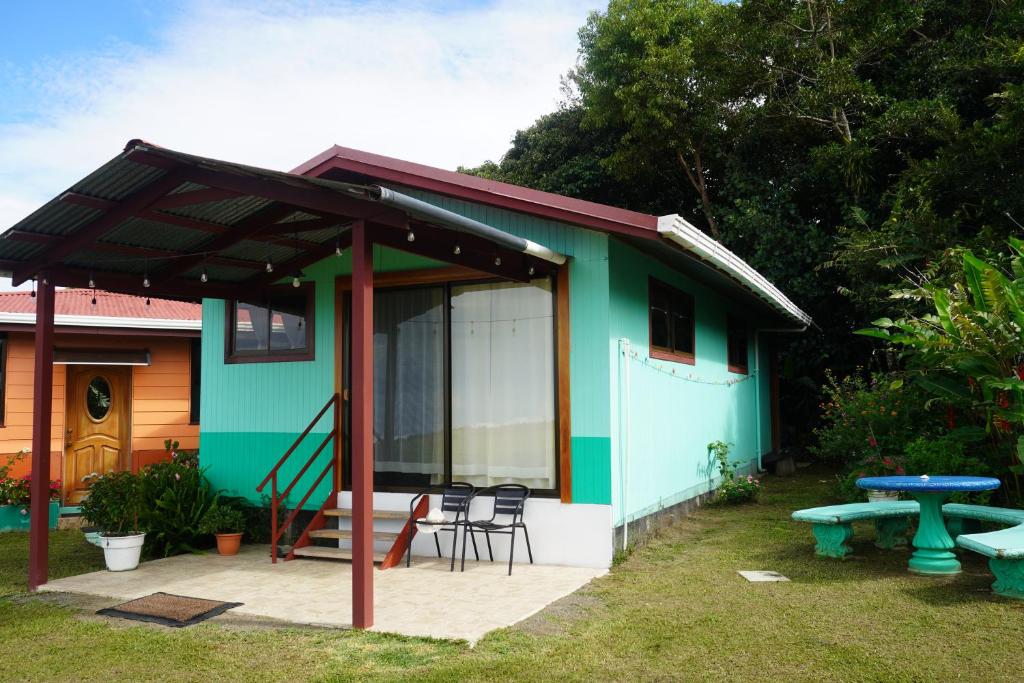 a blue and green house with a picnic table at Campo Azul #2 - Monteverde in Monteverde Costa Rica