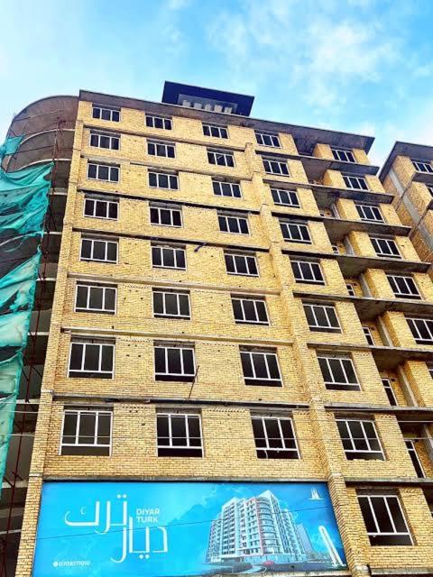 a tall building with a billboard in front of it at Mazar New palaza 