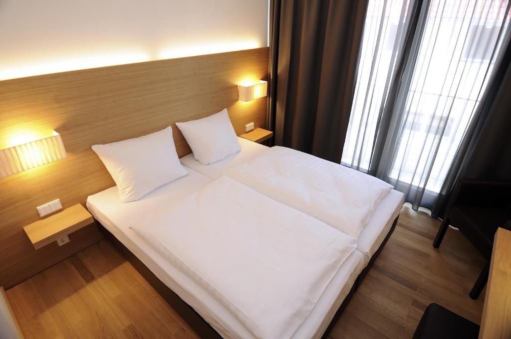 Postel nebo postele na pokoji v ubytování Hotel Thalmair