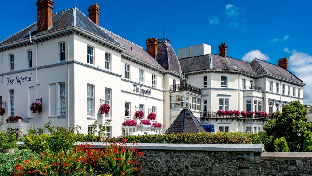 a large white building with flowers in front of it at The Imperial Hotel in Barnstaple