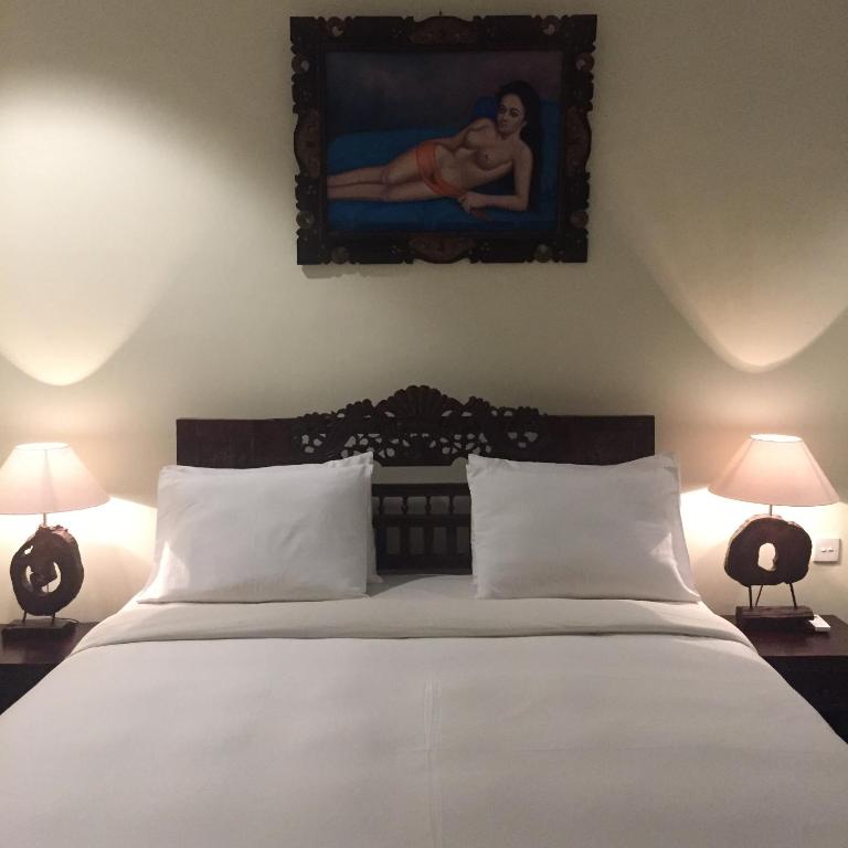 Postel nebo postele na pokoji v ubytování Ubud Wins Bungalow