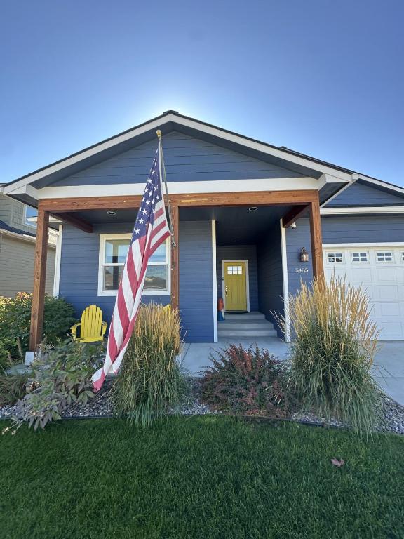 a house with an american flag in the front yard at Hometown Place in Missoula
