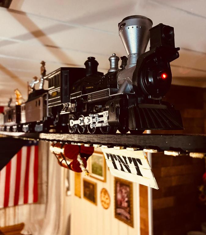 a toy train is on a track on a shelf at Pousada Vila do Cowboy in Penha