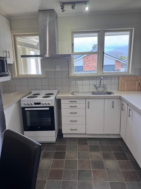 a kitchen with a stove and a sink at Bristol Motel - HOUSE in Upper Hutt
